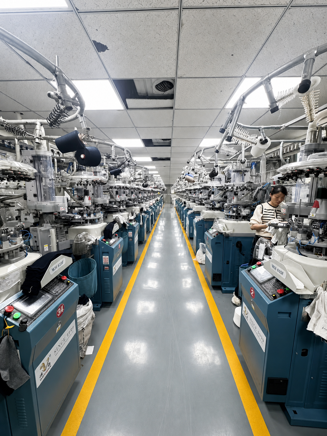 Rows of sock knitting machines on the family production floor