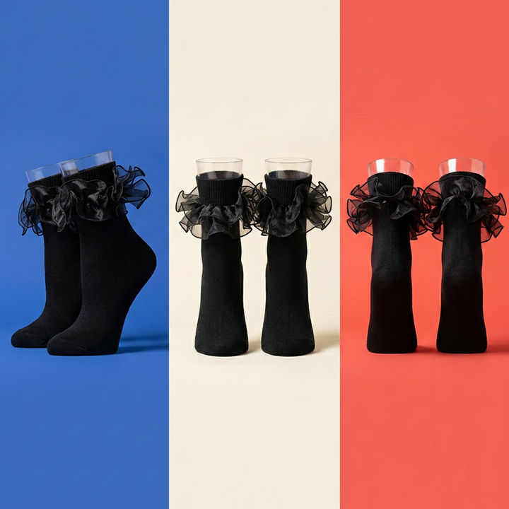 Black ruffle ankle socks displayed in three pairs against blue, cream and coral panels.
