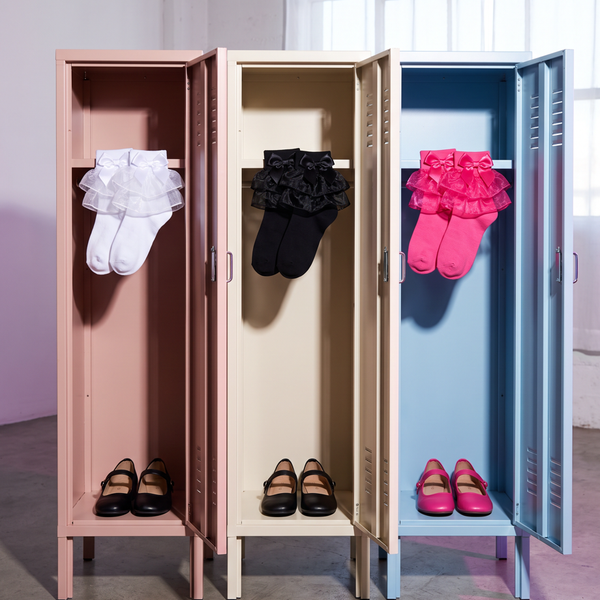 White, black and hot-pink ruffle socks with matching bows displayed as pairs in three pastel lockers.