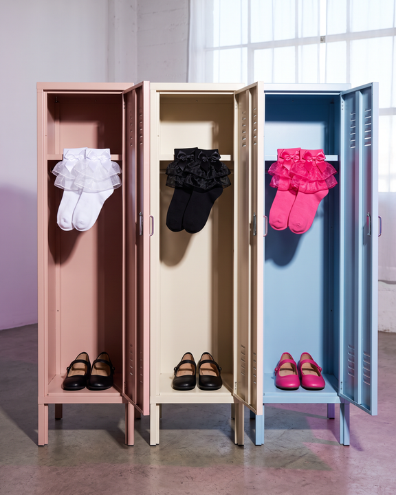 White, black and hot-pink ruffle socks with matching bows displayed as pairs in three pastel lockers.